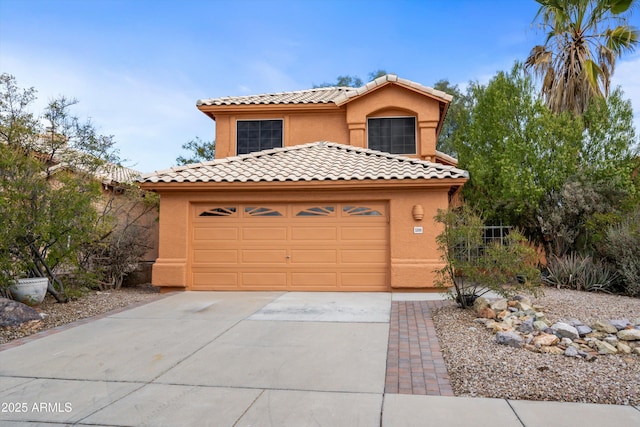 mediterranean / spanish-style house with a garage, driveway, stucco siding, and a tile roof