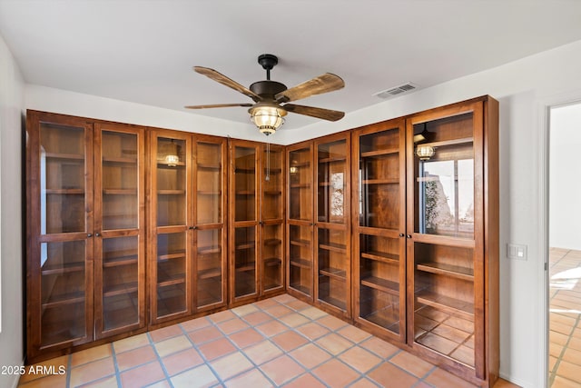 wine room with light tile patterned floors, visible vents, and a ceiling fan