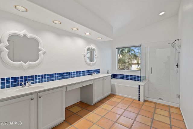 bathroom featuring a sink, double vanity, recessed lighting, a stall shower, and a garden tub