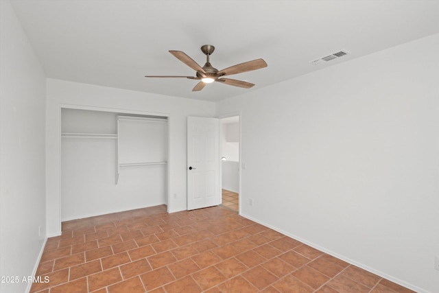 unfurnished bedroom featuring baseboards, visible vents, a closet, and a ceiling fan