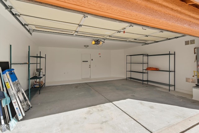 garage with visible vents and a garage door opener