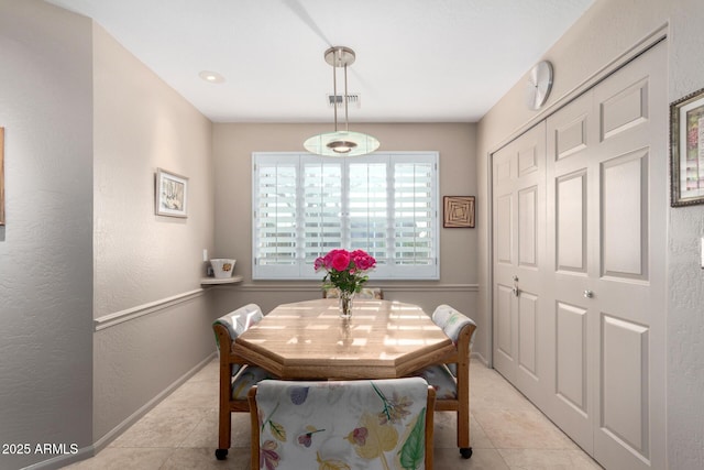 dining room with light tile patterned flooring and baseboards