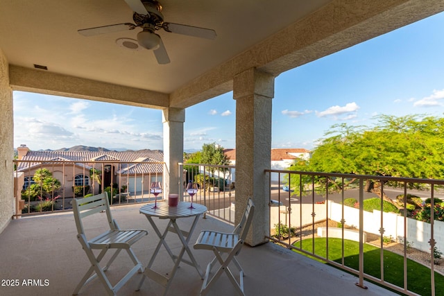 balcony with a ceiling fan and a residential view
