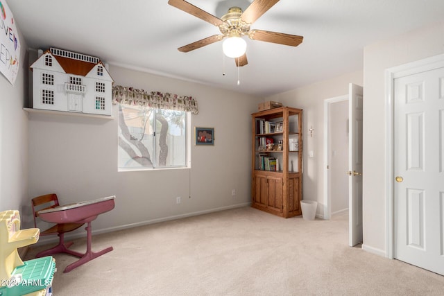 sitting room featuring carpet floors, ceiling fan, and baseboards
