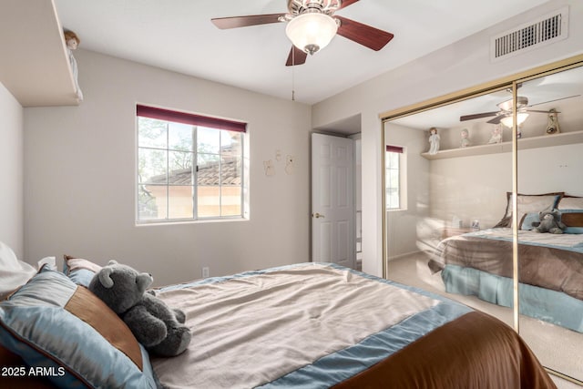 bedroom with a closet, carpet flooring, and ceiling fan