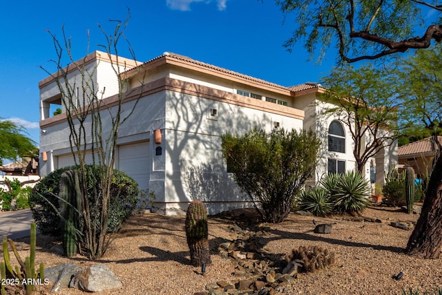 view of home's exterior featuring a tile roof and stucco siding