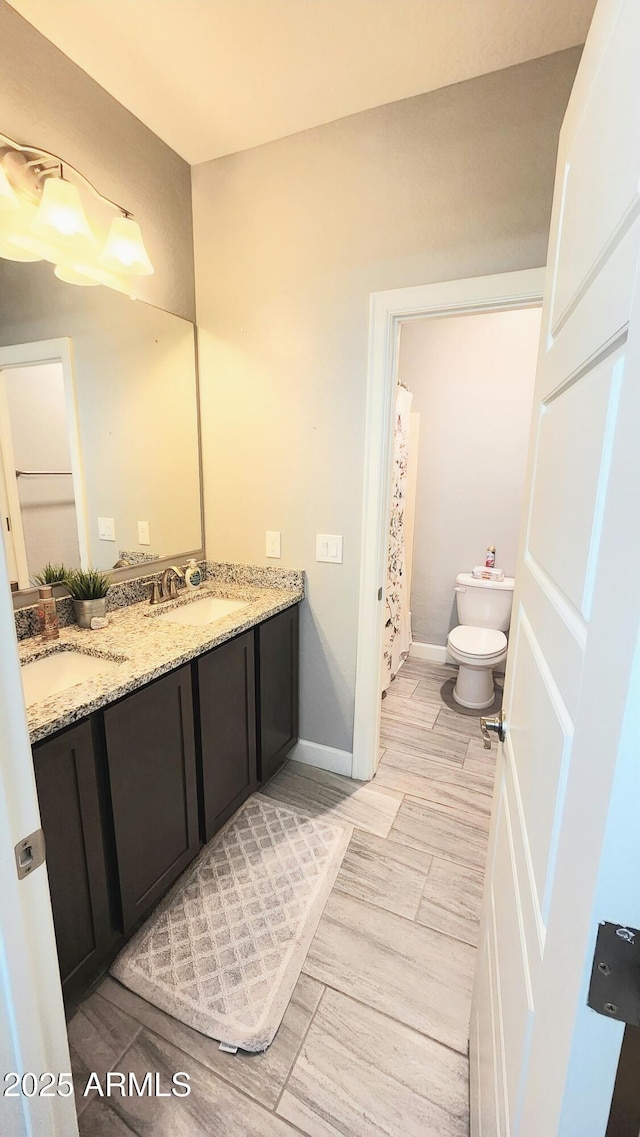 bathroom featuring toilet and vanity