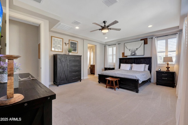 carpeted bedroom with ceiling fan, multiple windows, and connected bathroom