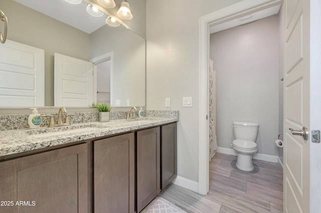 bathroom featuring toilet and vanity