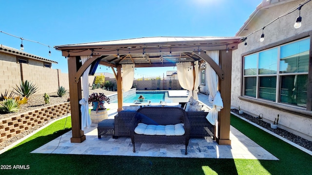 view of patio / terrace featuring a fenced in pool and a gazebo