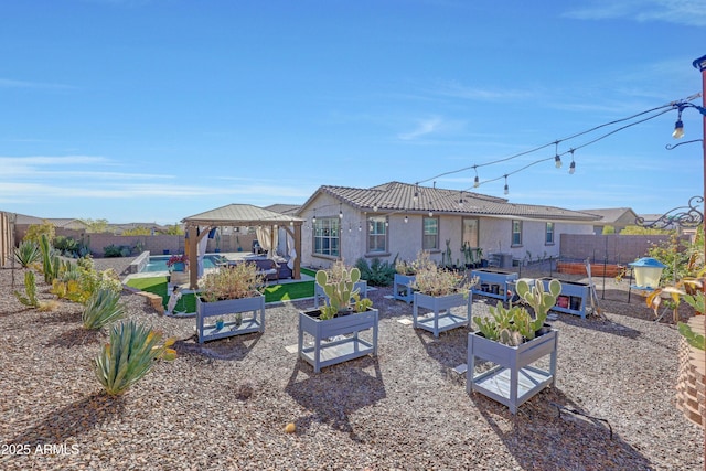 back of property featuring a gazebo and a fenced in pool