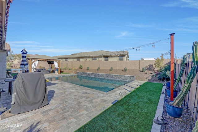 view of swimming pool with grilling area, a patio area, a gazebo, and a yard