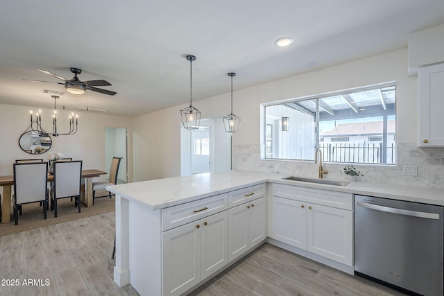 kitchen featuring dishwasher, light wood finished floors, white cabinetry, and a sink