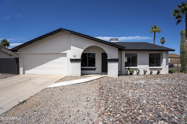 ranch-style house with an attached garage and concrete driveway