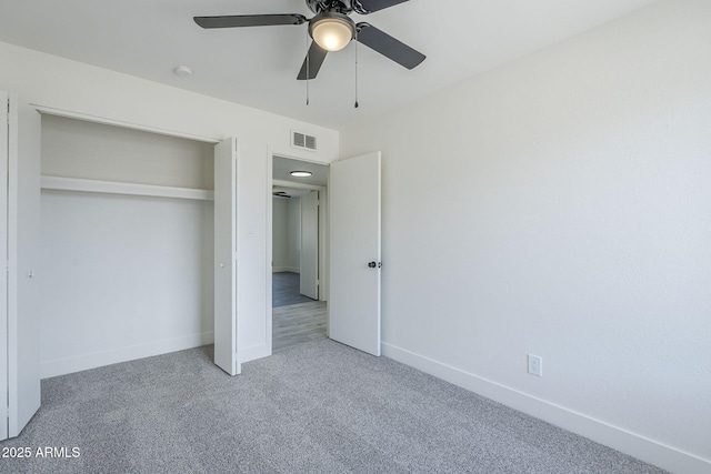 unfurnished bedroom featuring visible vents, a closet, baseboards, carpet flooring, and ceiling fan