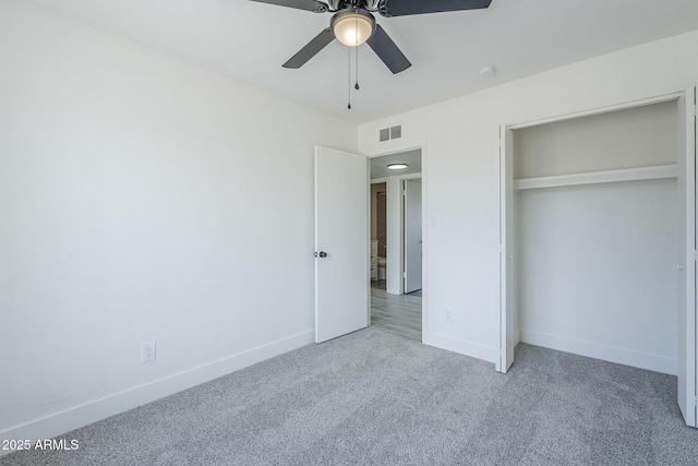unfurnished bedroom featuring baseboards, visible vents, a ceiling fan, a closet, and carpet floors