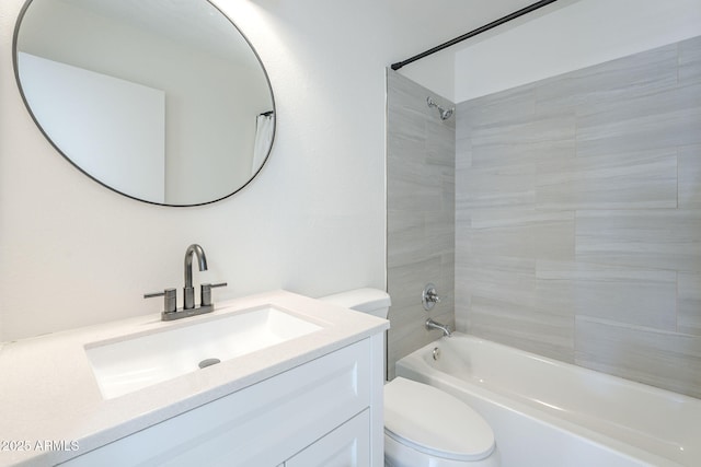 bathroom with toilet, vanity, and  shower combination