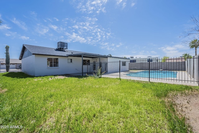back of house featuring a fenced in pool, cooling unit, fence, a patio area, and a yard