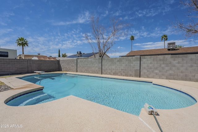 view of pool with a patio area, a fenced backyard, a fenced in pool, and a diving board