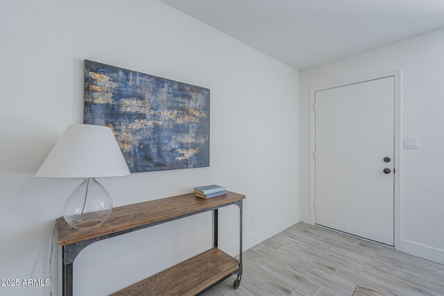 entryway featuring light wood-style floors and baseboards