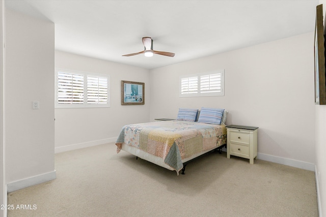 carpeted bedroom featuring baseboards and a ceiling fan