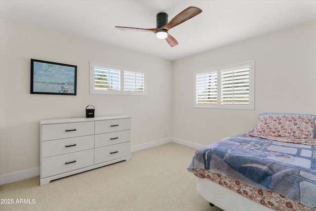 bedroom with light carpet, ceiling fan, and baseboards