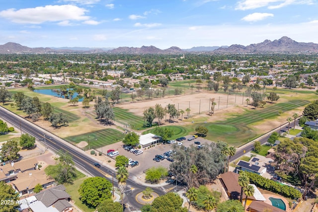 aerial view featuring view of golf course, a water and mountain view, and a residential view