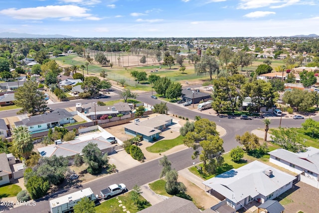 aerial view with view of golf course, a residential view, and a mountain view