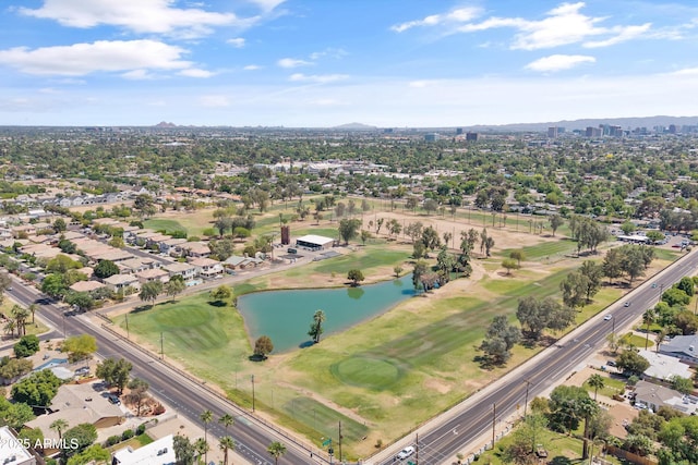 drone / aerial view with golf course view and a water and mountain view