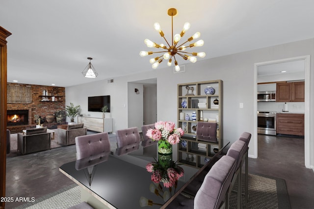 dining room with a fireplace and an inviting chandelier