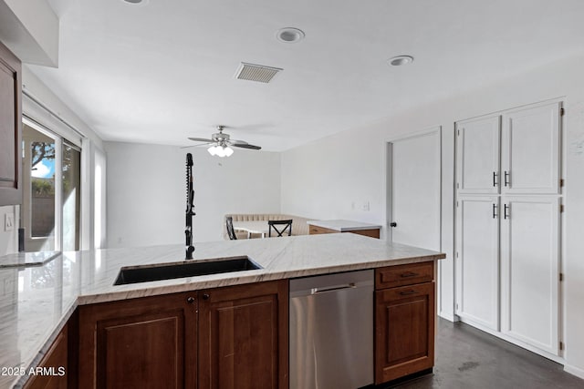 kitchen with sink, stainless steel dishwasher, ceiling fan, and light stone countertops