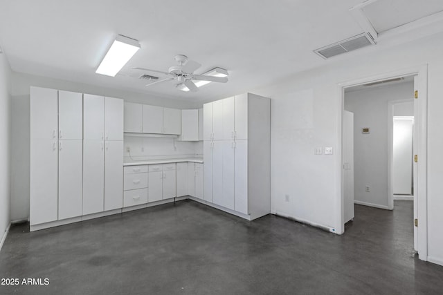 kitchen with ceiling fan and white cabinets