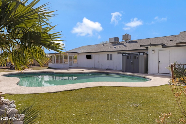 view of pool featuring a patio, a sunroom, a yard, and cooling unit