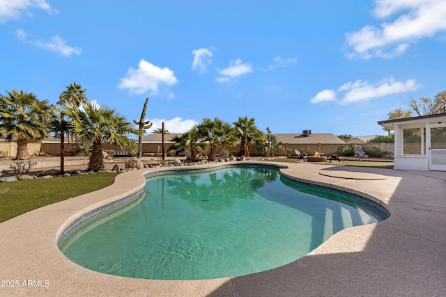 view of swimming pool featuring a sunroom and a patio