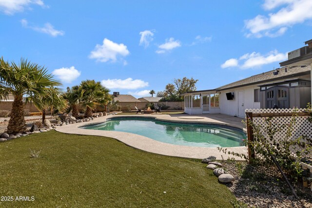 view of pool featuring a yard and a patio