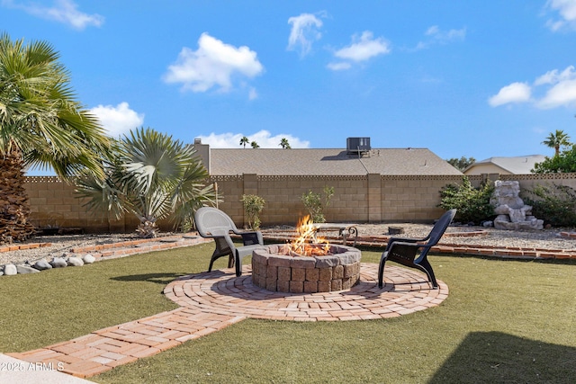 view of yard featuring cooling unit, a fire pit, and a patio