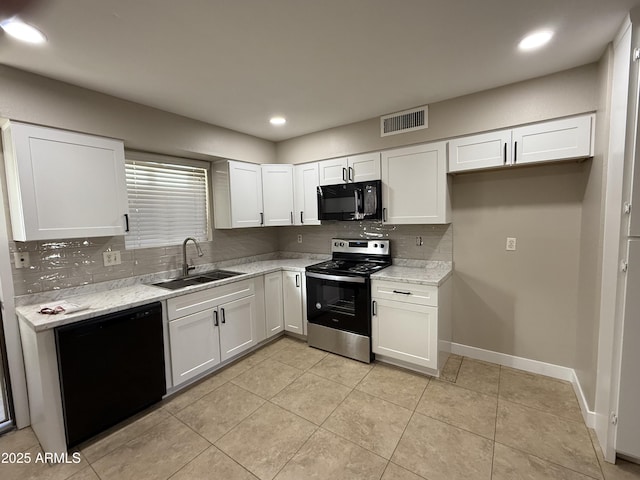 kitchen with white cabinets, a sink, tasteful backsplash, visible vents, and black appliances
