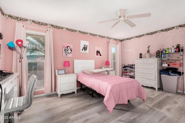 bedroom featuring ceiling fan and light hardwood / wood-style flooring