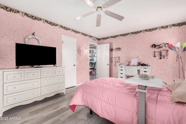 bedroom with ceiling fan and light wood-type flooring