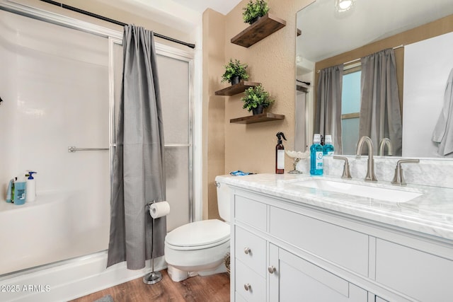 bathroom with hardwood / wood-style flooring, vanity, and toilet