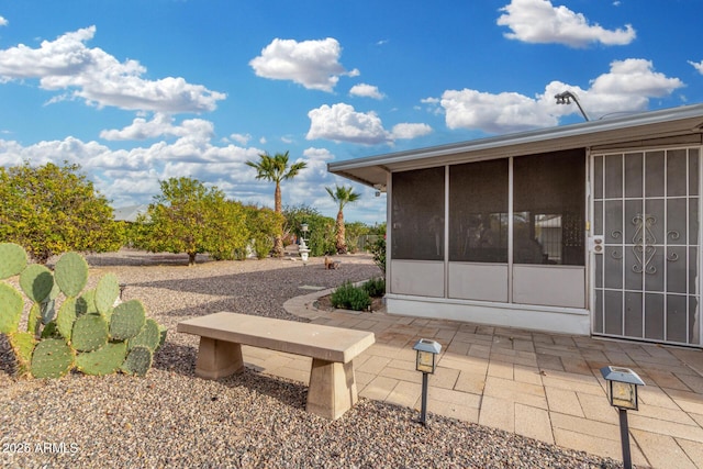 view of yard featuring a patio and a sunroom