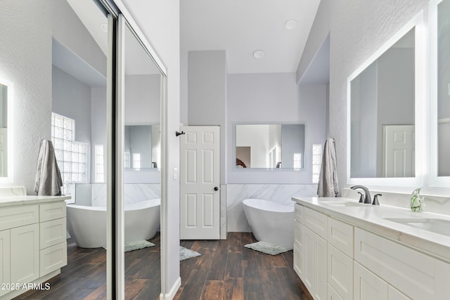 bathroom featuring vanity, a tub, and hardwood / wood-style floors