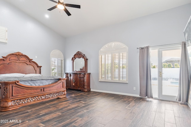 bedroom featuring multiple windows, dark hardwood / wood-style flooring, and access to outside