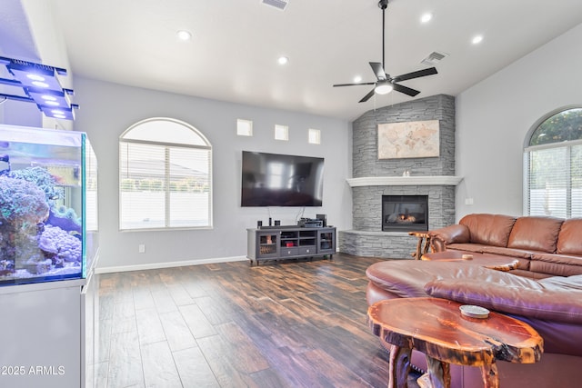 living room with ceiling fan, a fireplace, dark hardwood / wood-style flooring, and vaulted ceiling