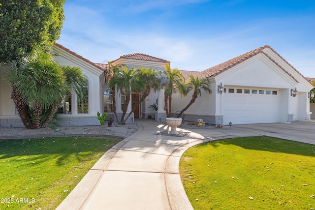 mediterranean / spanish home with a garage and a front lawn