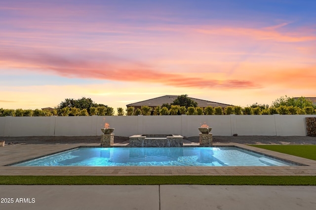 view of pool at dusk