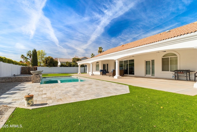 exterior space featuring a patio, a grill, and a yard