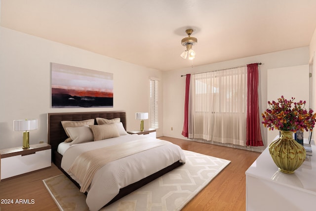 bedroom featuring hardwood / wood-style floors and ceiling fan