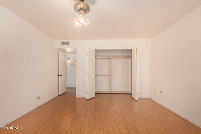 unfurnished bedroom featuring light hardwood / wood-style flooring and a closet