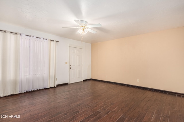 unfurnished room with dark hardwood / wood-style flooring and ceiling fan